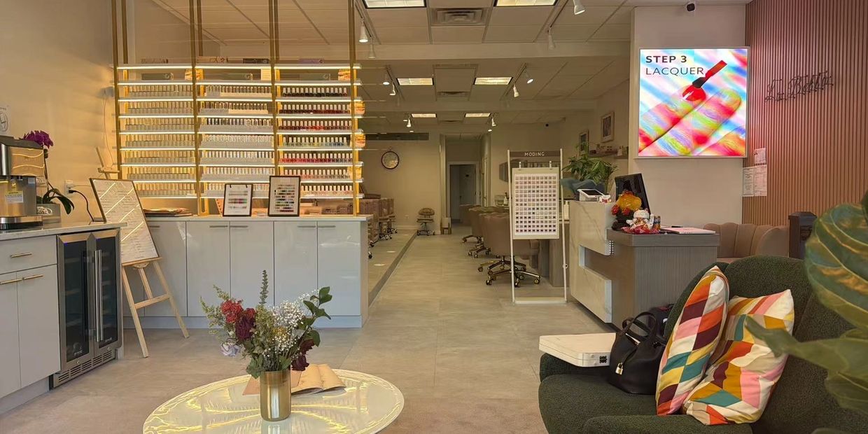 Modern nail salon interior with organized nail polish display and cozy seating.