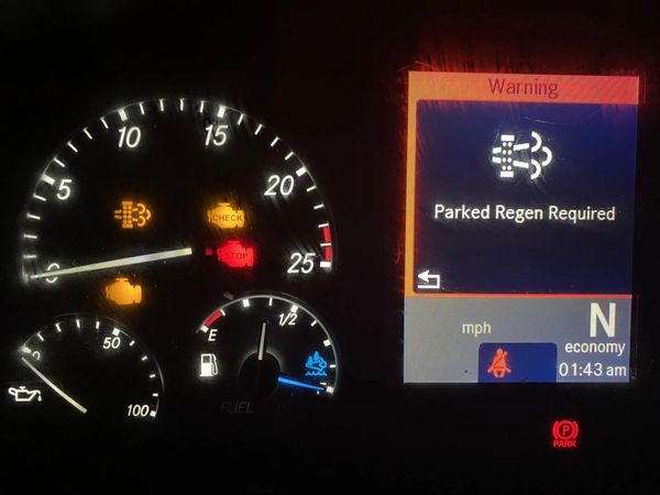 Vehicle dashboard showing warning lights and 'Parked Regen Required' message.
