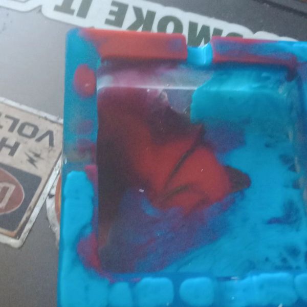 Close-up of a colorful, abstract object with red and blue hues.