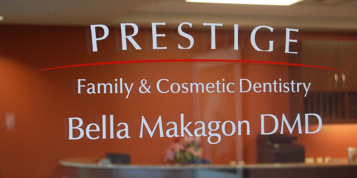 Prestige Family and Cosmetic Dentistry Logo as seen on the glass entry doorway to the dental office. 