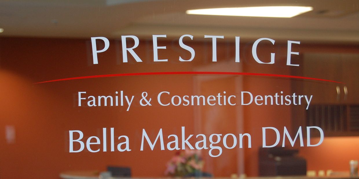 Prestige Family and Cosmetic Dentistry Logo as seen on the glass entry doorway to the dental office. 