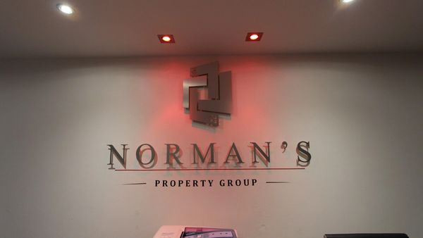 Wall with Norman's Property Group logo
