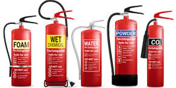 Various types of fire extinguishers arranged side by side.