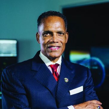 Confident man in a suit smiling.
