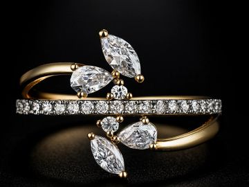 Elegant gold ring with sparkling diamonds in leaf shapes.
