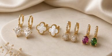 Four pairs of elegant gold earrings with various gemstones and designs.