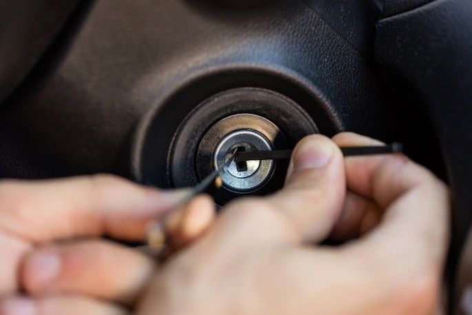 Mobile locksmith repairing automotive lock.