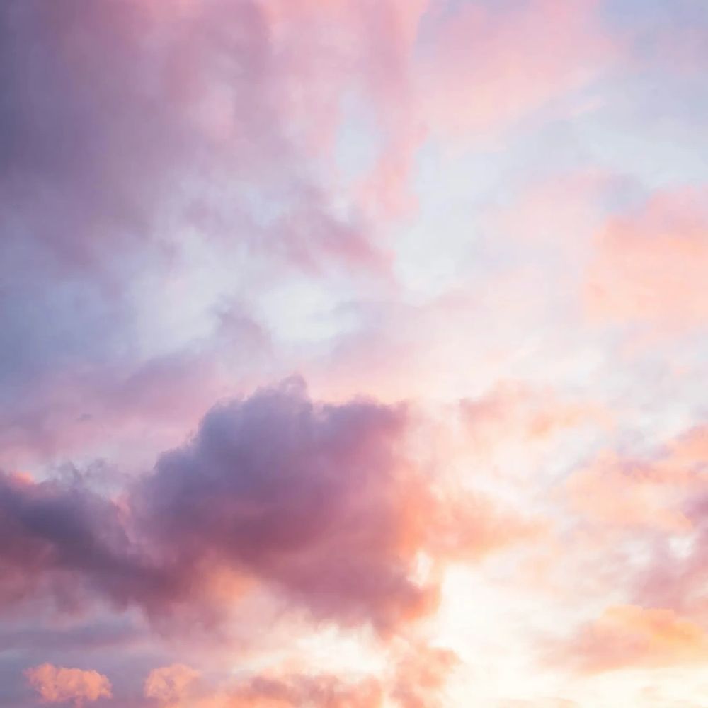 A pastel-colored sky with soft pink and purple clouds.