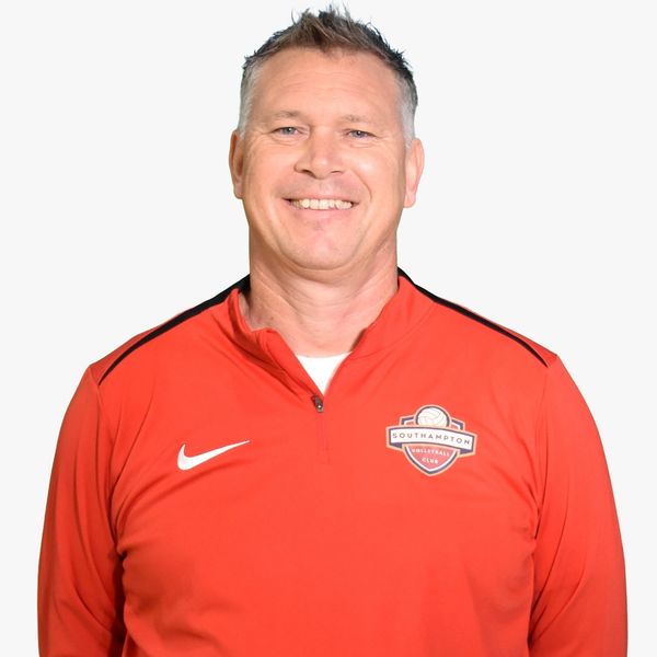 Smiling man in red Southampton Volleyball Club jacket.
