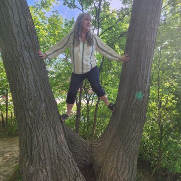 Deb on a sunny day, climbing in a tree.