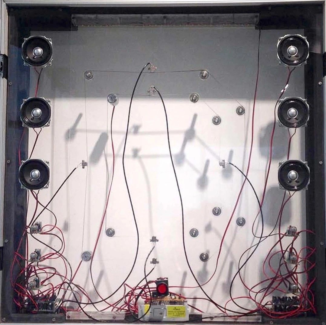 An intricate setup featuring multiple speakers and an array of wires connected to various components, possibly for an audio project or experiment.