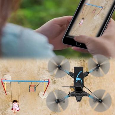Drone captures a child on a swing, viewed live on a smartphone.