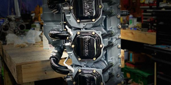 Close-up of a vintage Avco Lycoming aircraft engine in a workshop.