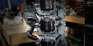 Close-up of a vintage Avco Lycoming aircraft engine in a workshop.