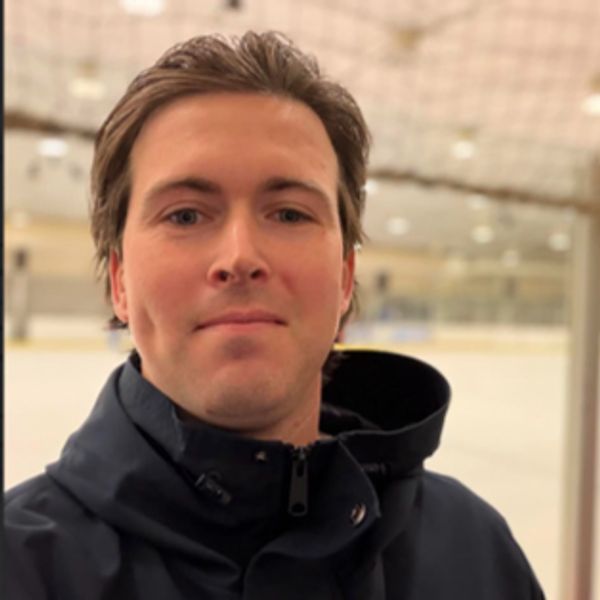 Man taking a selfie in an indoor ice rink.