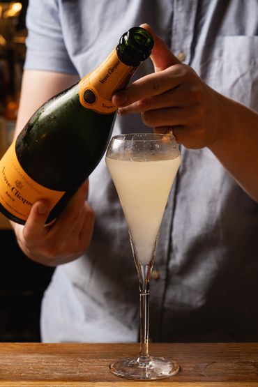 A man pouring a glass of champagne 