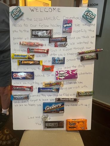 Welcome poster with candy bars at a hockey convention.