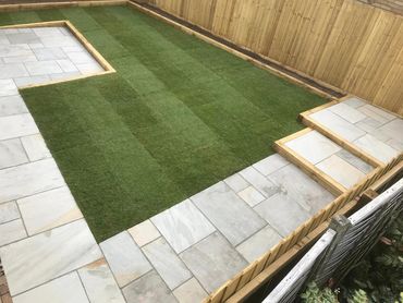 Sandstone patio turf fencing and retaining sleepers