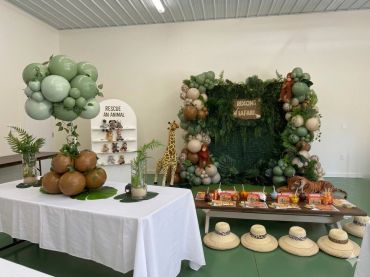 Jungle-themed party setup with balloons, animal figures, and rescue an animal display.