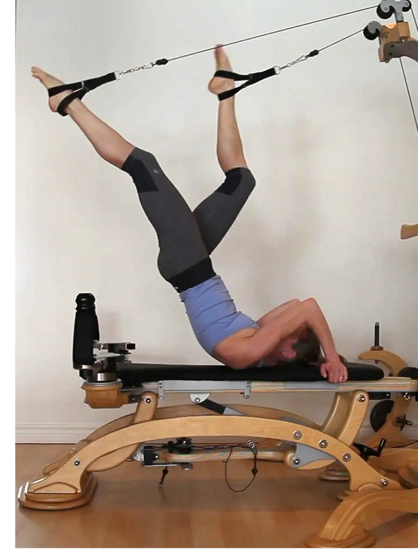 athletic woman exercising with the Gyrotonic equipment