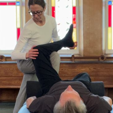 Ilan Lev Method therapist during treatment inside church with stained glass window in background