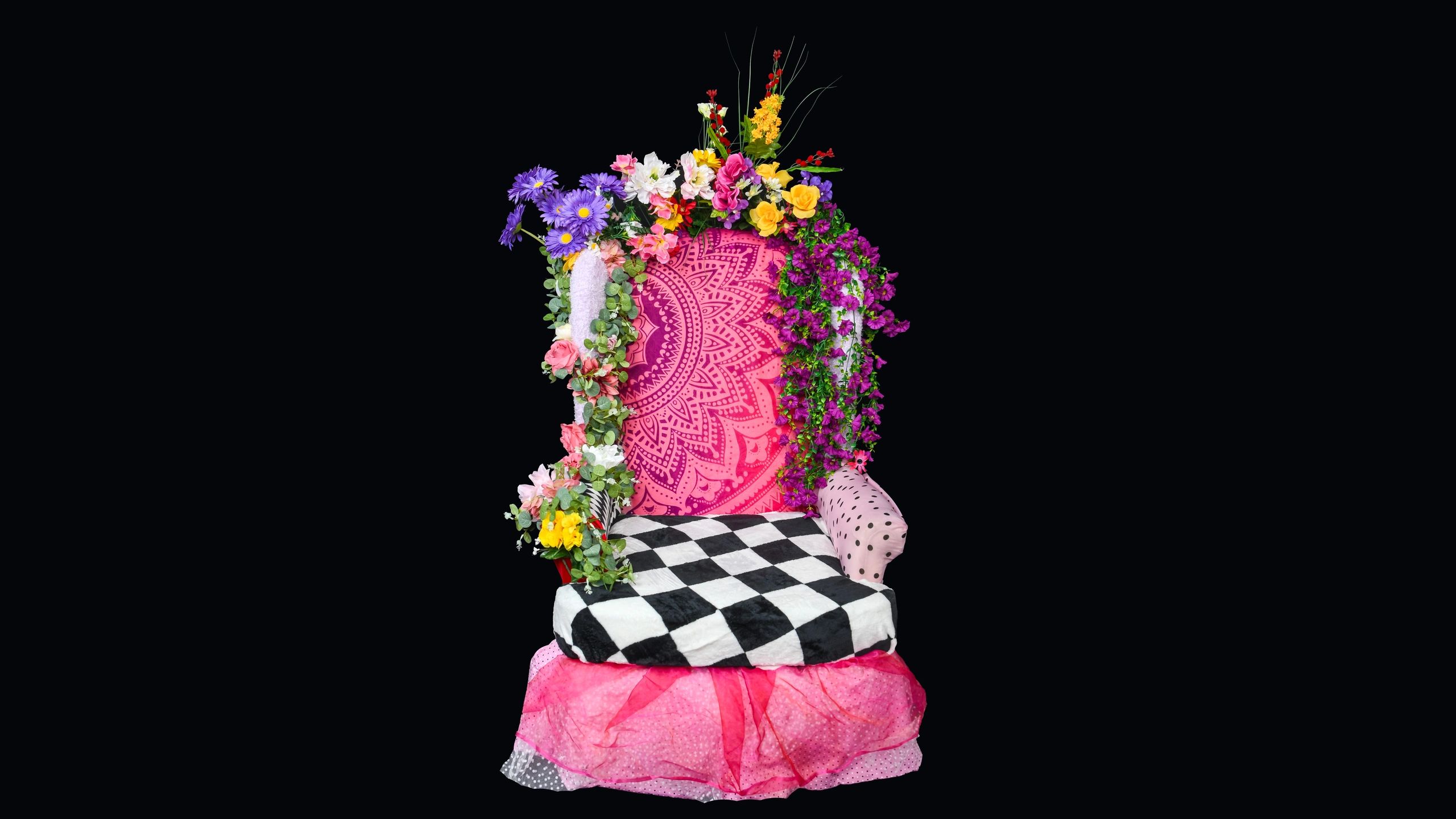 Colorful floral decorated chair with black background.
