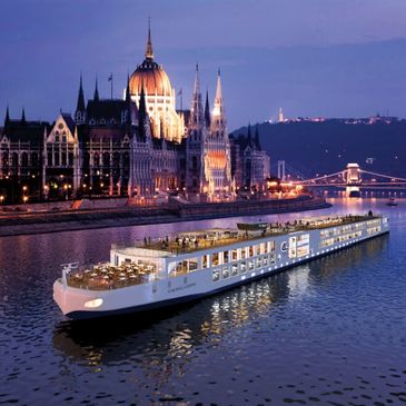 A river cruise ship peacefully sailing down the Danue Rver at sunset.