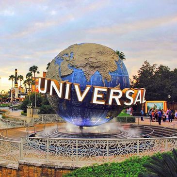 The iconic Universal Studios globe spinning with water fountains at the theme park entrance.