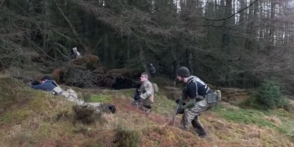 A group of Royal Huntsman team members playing an Airsoft game in Scotland.