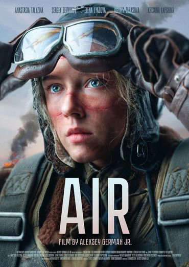 Close-up of a determined pilot with reflective goggles and scars, from the film Air.