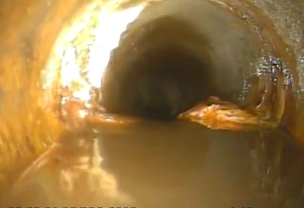 CCTV drain inspection showing standing water and restricted flow inside drainage pipework