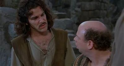 Two men dressed in medieval attire engaged in conversation.
