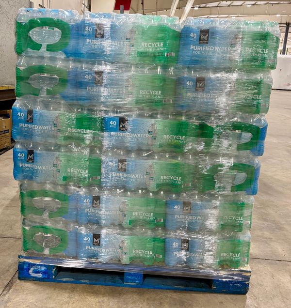 Pallet stacked with multiple packs of 40 bottles of purified water.