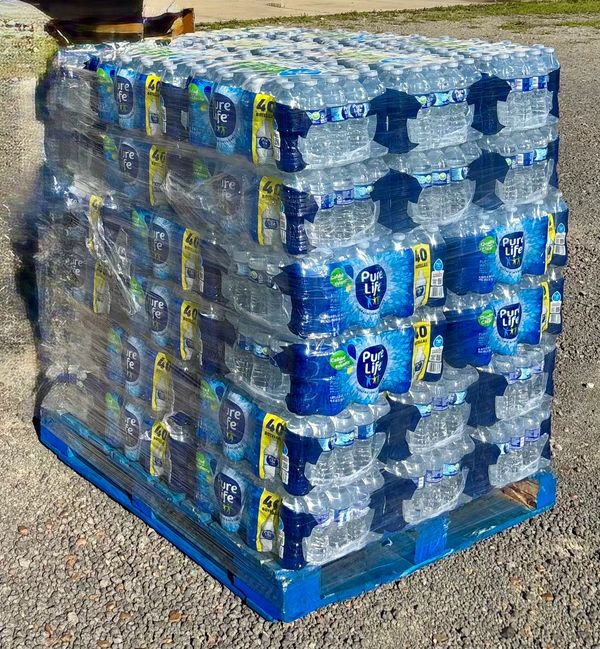 Large pallet stacked with multiple packs of Pure Life bottled water.