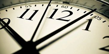 Close-up of clock hands near 12 o'clock.