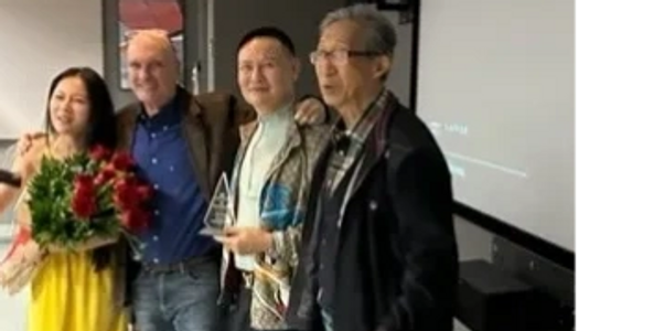Director Patrick Bienvenu presenting awards.