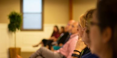 Ladies sitting in an audience watching a presentation