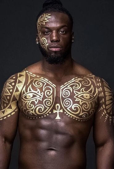 Male with gold tribal body paint art