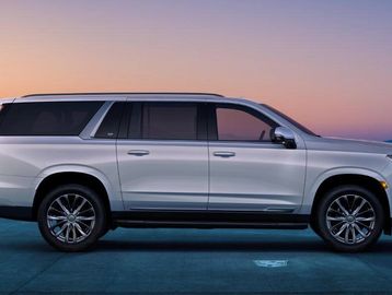 Silver SUV parked at dusk with a clear sky.