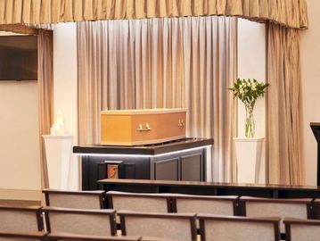 A coffin at a funeral service setup.