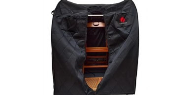 A black portable photo studio tent with a chair inside.