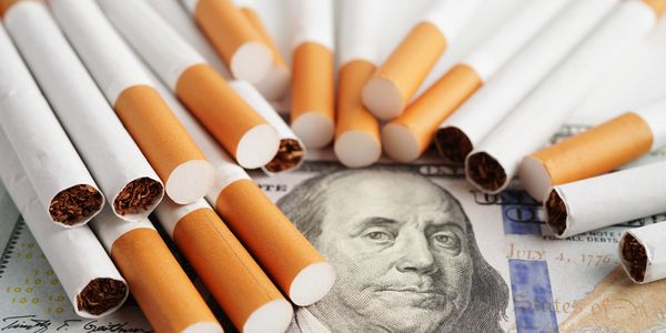 a bunch of cigarettes covering currency 