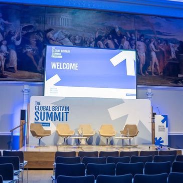 A stage set up for a conference, the backdrop reads 'The Global Britain Summit'.