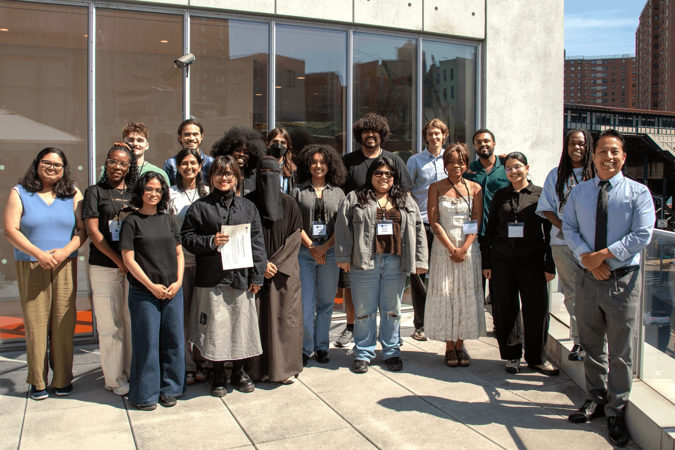 2026 Cohort participants standing & smiling for a group photo.
