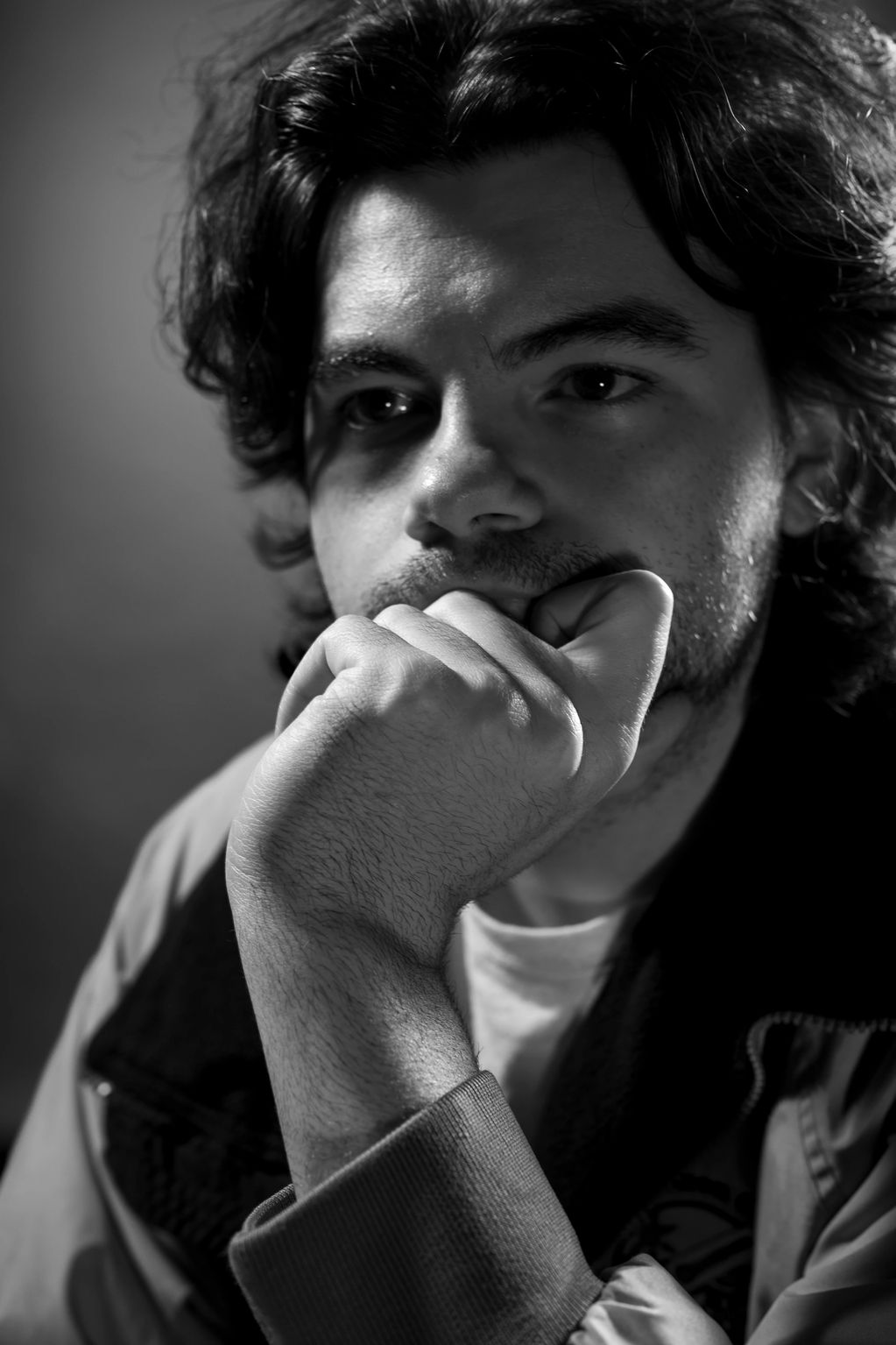 Black and white close-up of a thoughtful man.