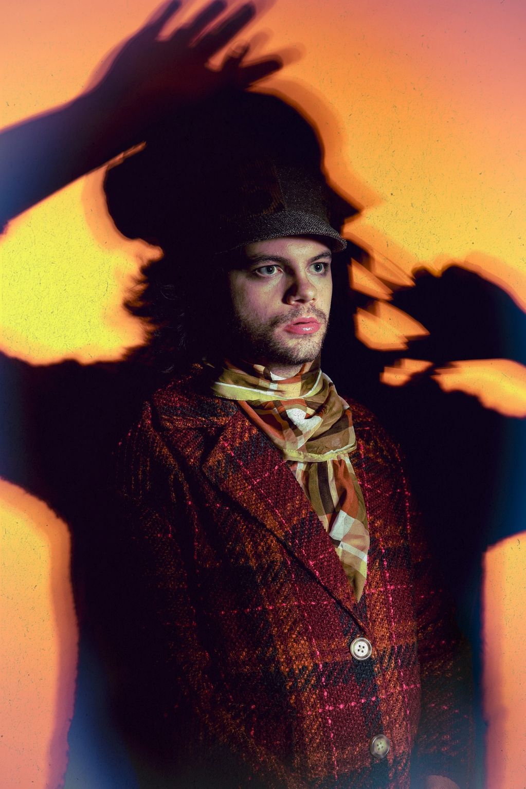Portrait of a man in vintage clothing with dramatic shadow play.