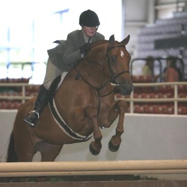 Debbie Brawley jumping at a horse show