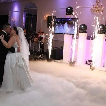 Bride and groom share first dance with special effects.