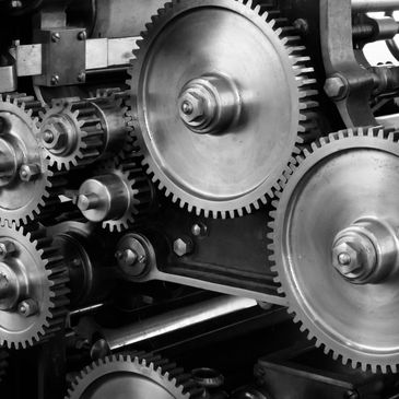Close-up of interconnected metal gears in a machine.