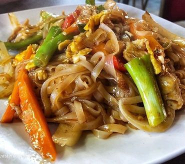 Plate of stir-fried noodles with vegetables and egg.